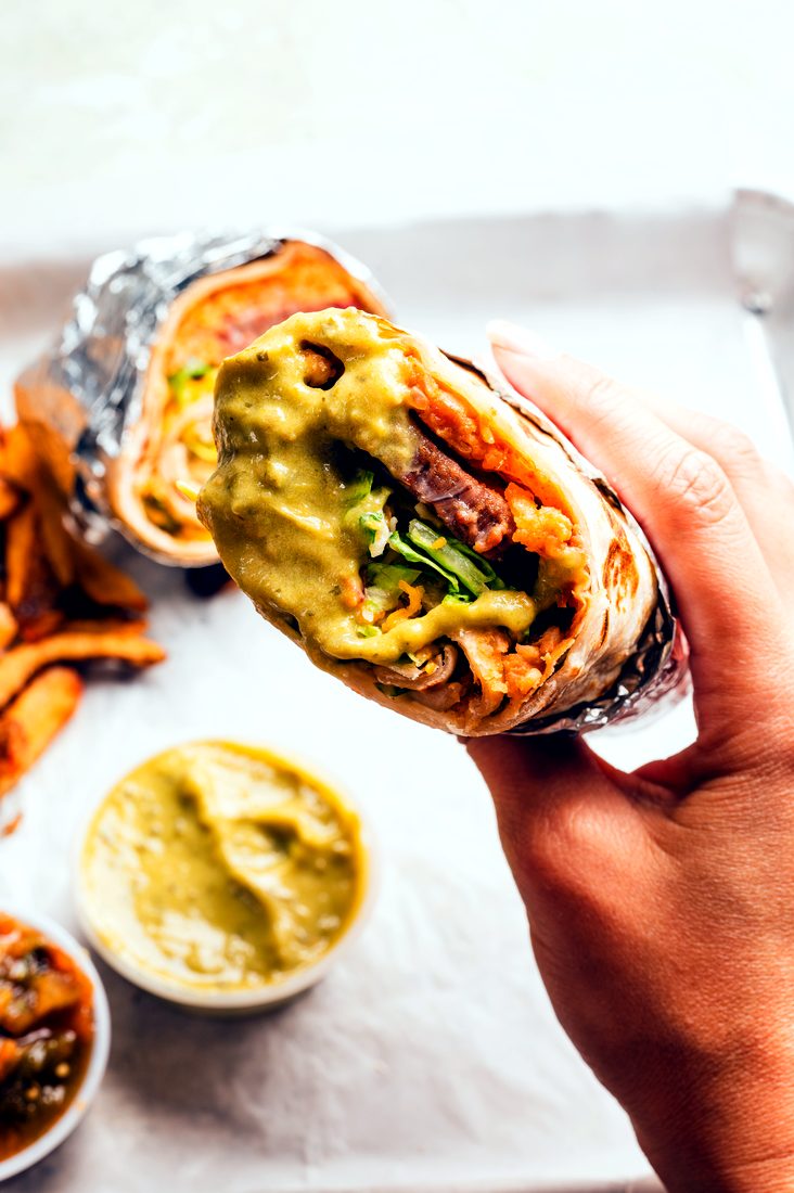 South Texas Restaurant Campaign — A burrito cross-section, handheld and close.